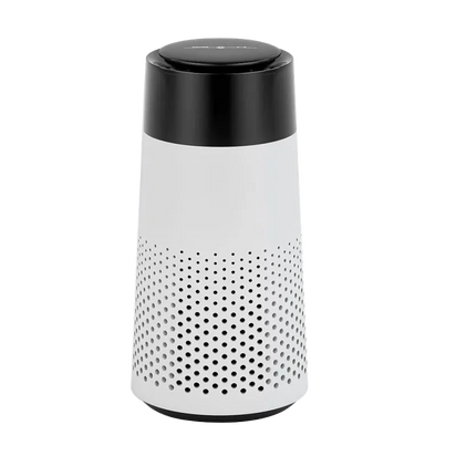 White cylindrical device with black perforated top on a white background
