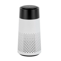 White cylindrical device with black perforated top on a white background