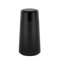 Black cylindrical device with perforated design on a white background