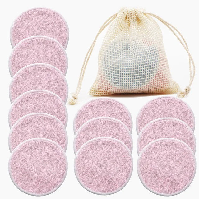 Set of pink reusable makeup pads with a mesh storage bag on a white background